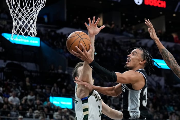 Jan 4, 2024; San Antonio, Texas, USA; San Antonio Spurs guard Tre Jones (33) drives to the basket while defended by Milwaukee Bucks guard Pat Connaughton (8) during the second half at Frost Bank Center.